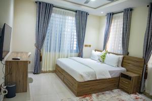 a bedroom with a bed and a large window at Parkview Air B&B in Accra