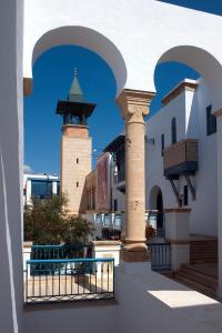a view of a building with a gate and a tower at Diar Lemdina Hotel in Hammamet