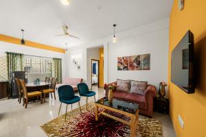 a living room with a couch and a table at Susan Grand penthouse in Bengaluru
