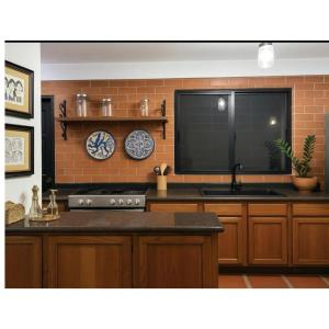 a kitchen with a stove and a brick wall at Comfort and a perfect location in Valencia