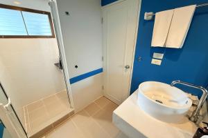 a bathroom with a white sink and a shower at Days Inn by Wyndham Patong Beach in Patong Beach