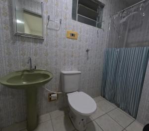 a bathroom with a toilet and a sink and a shower at LumeHostel in João Pessoa