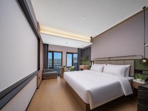 Llit o llits en una habitació de 义乌君忆云澜国际酒店 Yiwu Junyi Yunlan International Hotel