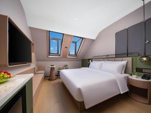 Llit o llits en una habitació de 义乌君忆云澜国际酒店 Yiwu Junyi Yunlan International Hotel