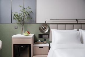 Llit o llits en una habitació de 义乌君忆云澜国际酒店 Yiwu Junyi Yunlan International Hotel