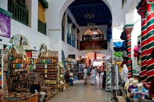 a group of people walking through a market at Diar Lemdina Hotel in Hammamet