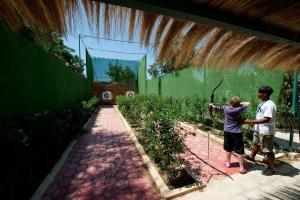 a man and a woman standing in a garden at Diar Lemdina Hotel in Hammamet