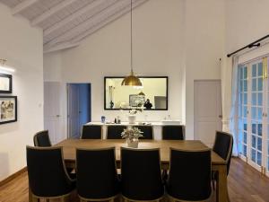 a dining room with a wooden table and chairs at The Eight at Willows in Upcot