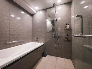 a bathroom with a bath tub and a shower at Minn Asakusa in Tokyo