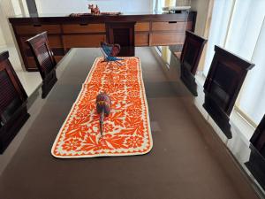 a large rug on a table in a room at Casa Fibonacci en Oaxaca in Oaxaca City