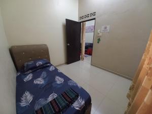 a bedroom with a bed and a door to a hallway at Homestay DC 1 - wifi, netflix in Shah Alam