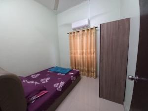 a small room with a bed and a curtain at Homestay DC 1 - wifi, netflix in Shah Alam