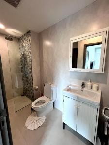 ein Badezimmer mit Toilette, Waschbecken und Spiegel in der Unterkunft B9 Ватсап669З5В2I976 in Nai Yang Beach