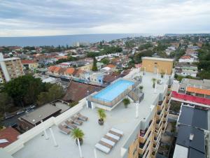 an overhead view of a city with a swimming pool at HolidayRento Bondi Rooftop Pool & Air Con Studio in Sydney