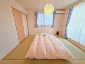 a bedroom with a bed in the middle of a room at Peaceful Garden Home in Ota, Entire 3BR Parking in Ota +35 photos