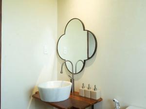 a bathroom with a sink and a mirror on a wall at Aki Eco-villa Hội An in An Bang +21 photos