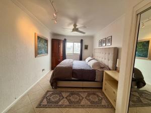 a bedroom with a bed and a ceiling fan at Oceanview Casita 1BR 1 5BA with pool in Rosarito