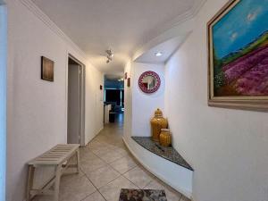a hallway with a bench and a painting on a wall at Oceanview Casita 1BR 1 5BA with pool in Rosarito