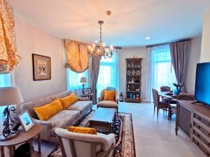 a living room with a couch and a table at THE CASTELL CONDOMINIUM KHAOKHO BY Veerayut in Campson