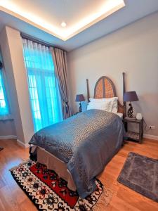 a bedroom with a bed with two lamps and a rug at THE CASTELL CONDOMINIUM KHAOKHO BY Veerayut in Campson