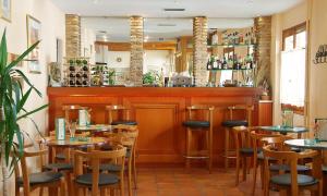 a dining room with tables and a bar at Acropole Delphi City Hotel in Delphi
