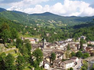 a small town in a valley with mountains at Val Del Rio in Fiumalbo
