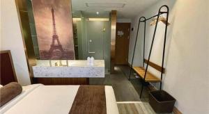 a bedroom with a bed and a bathroom with the eiffel tower at James Joyce Coffetel·Shanghai Zhuanqiao Wanda Plaza in Shanghai +279 photos