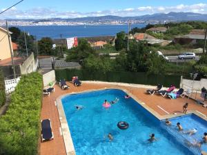 a group of people in a swimming pool at Hostal Las Vegas in Cangas de Morrazo