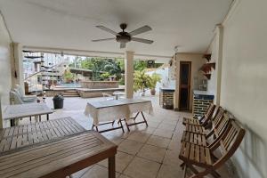 a patio with chairs and a table and a ceiling fan at Elicon Suites Resort Bohol near City Center in Tagbilaran City