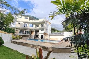an exterior view of a house with a swimming pool at Elicon Suites Resort Bohol near City Center in Tagbilaran City