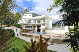 an image of a house with a swimming pool at Elicon Suites Resort Bohol near City Center in Tagbilaran City