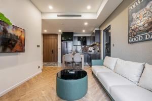a living room with a couch and a table at LUMIERE RIVERSIDE LUXURY APARTMENT 5STar in Ho Chi Minh City