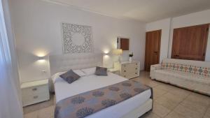 a hotel room with a bed and a couch at Residence Maresol in Vieste +37 photos