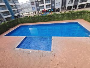 an empty swimming pool in front of a building at Favorite Staycation by Janice - Modern Comfort Near Airport in Nairobi