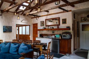 a living room with a blue couch and a kitchen at Riverstone Acres in Waihi