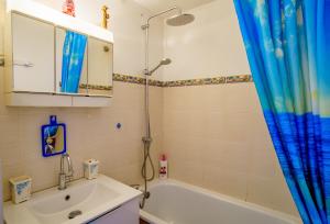 a bathroom with a tub and a sink and a shower at La Marina in Saint-Cyprien-Plage +50 photos