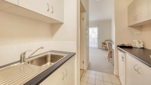 a kitchen with a sink and a counter at Capella Coach Inn in Capella