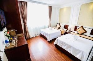 Postel nebo postele na pokoji v ubytování ORANGE Hotel - City CENTER, near Dragon Bridge, Han River, international airport