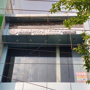 a sign on the side of a building at EMERGE HOTEl in Hardoī