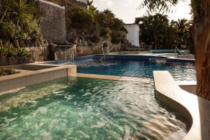 a swimming pool with clear water in a resort at Apollon Club & Thermal Spa in Ischia