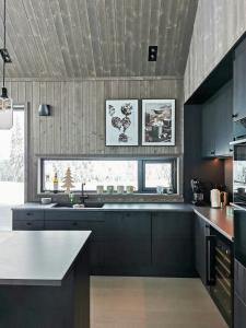a kitchen with blue cabinets and a white counter top at Family Cabin With Annexe In Haglebu in Eggedal