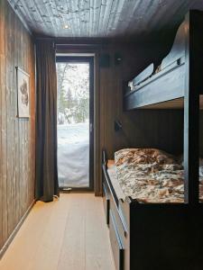 a bedroom with a bunk bed and a window at Family Cabin With Annexe In Haglebu in Eggedal