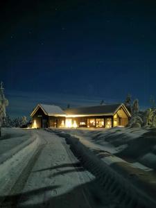 a house in the snow at night at Family Cabin With Annexe In Haglebu in Eggedal