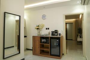 a room with a mirror and a wooden cabinet at استديوا " بلكونه " in Riyadh +11 photos