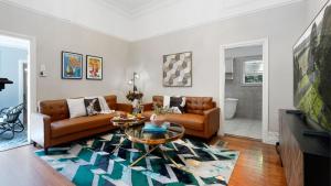 a living room with a couch and a table at Secret Garden in Bowral