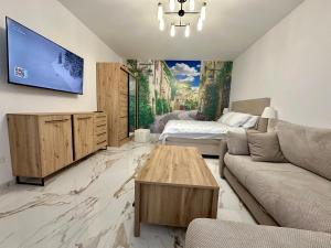 a living room with a couch and a tv on a wall at Stunning Sea View - Brand New Apartments in Kotor