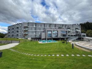 a large building with a green lawn in front of it at Utsikten Hotell Kvinesdal - Unike Hoteller in Kvinesdal