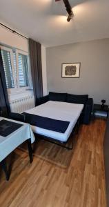 a bedroom with a large bed and a wooden floor at Apartment Vidak in Labin