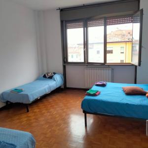 a room with two beds and a large window at Carlo e Dani Flat in Venice in Venice
