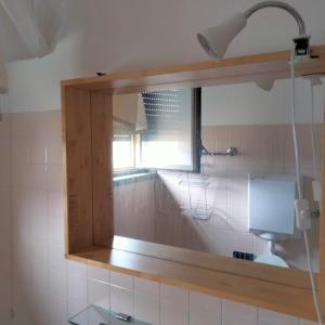 a mirror in a bathroom with a window at Carlo e Dani Flat in Venice in Venice +19 photos
